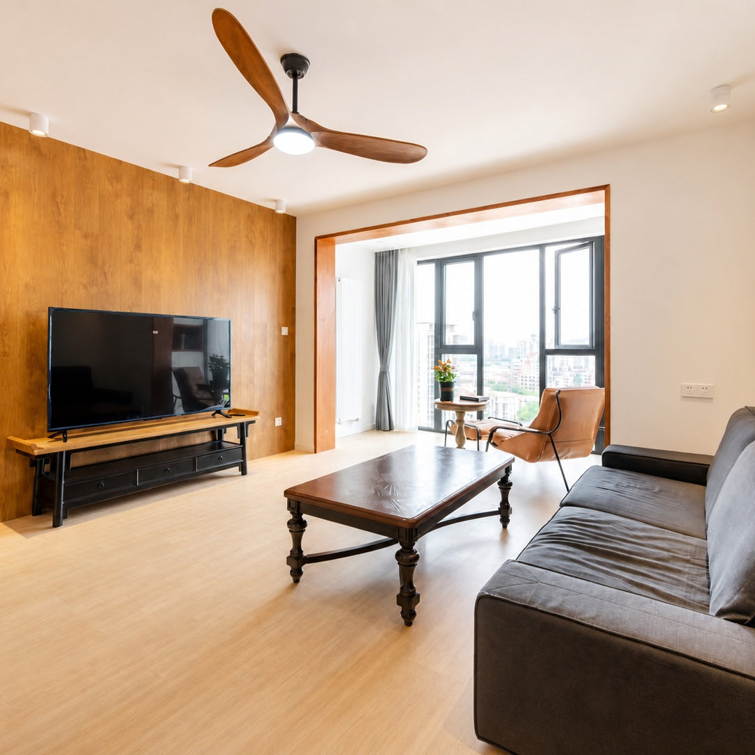 Ceiling fan with light wood blades and white frosted light cover on dark motor