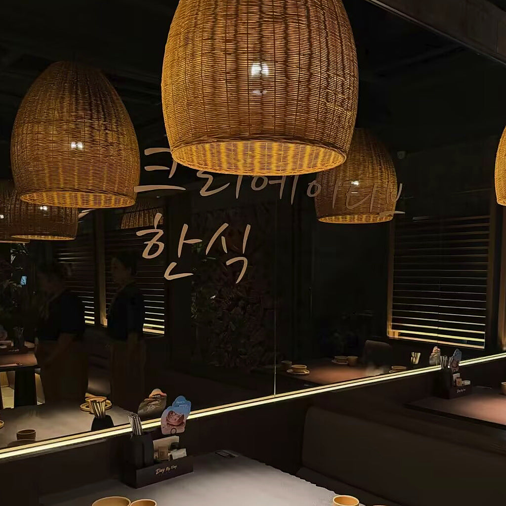Rattan bell pendant cluster with woven conical shades and warm light