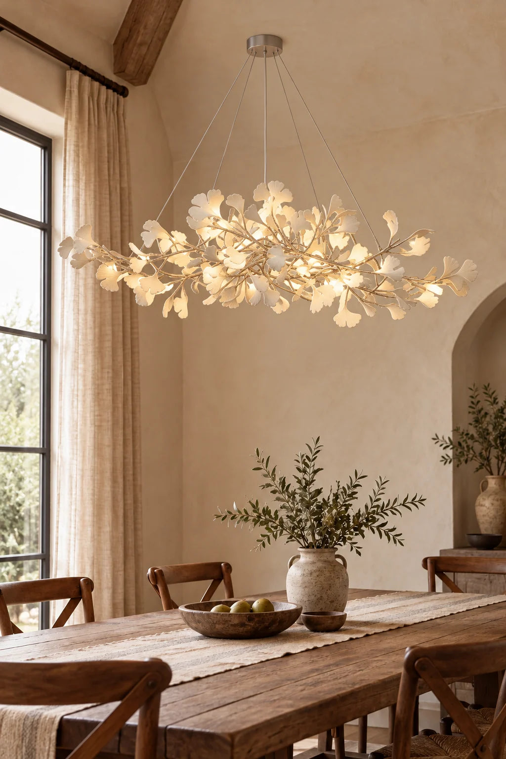 Gingko Bough Chandelier with ivory leaf forms above a dining table